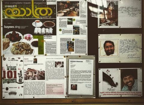 Kayees Rahmathulla Cafe Mattancherry inside wall paper cuttings about restaurant