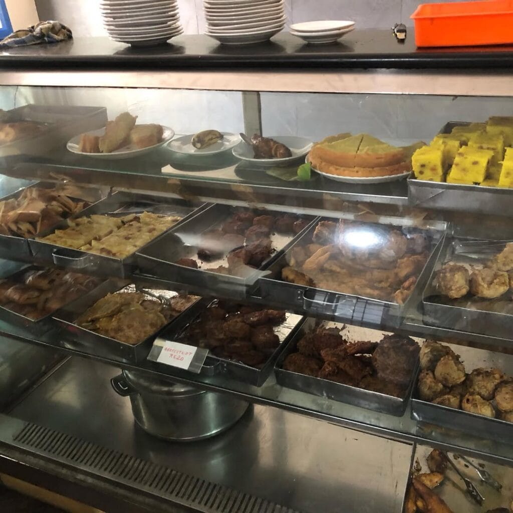 Bombay hotel kozhikode snacks corner display with various fried items and sweets