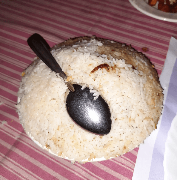 chicken dum biriyani with a spoon at Bombay Hotel, Kozhikode