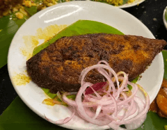 fish fry on a white serving plate with onions