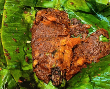 kerimeen pollichathu dish of tharavad seafood restaurant