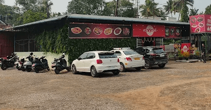 tharavadu seafood restaurant front view with parking slots